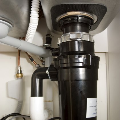 A garbage disposer under the kitchen sink